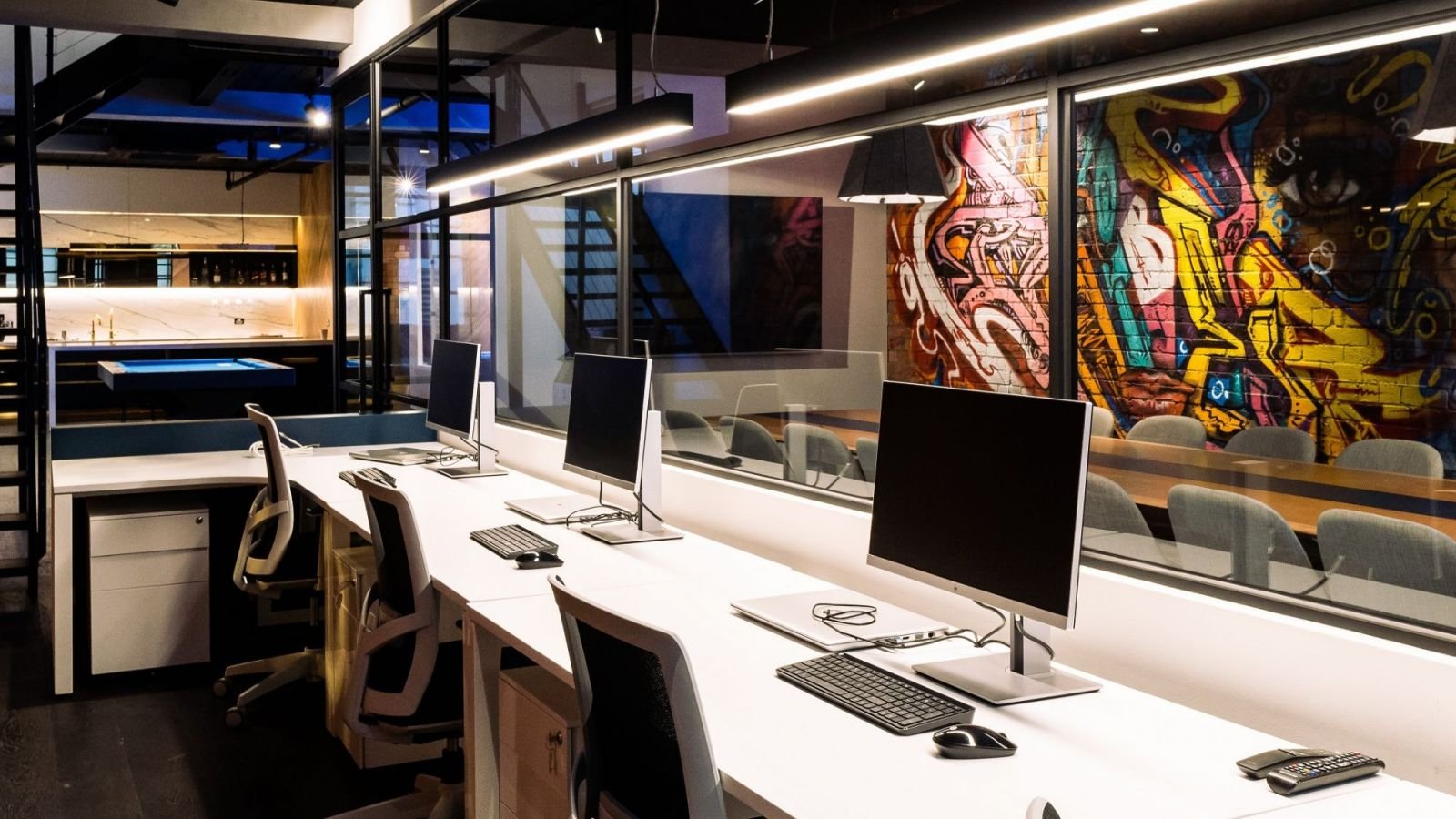 Dywinds team collaborating in a modern office space with laptops and whiteboards